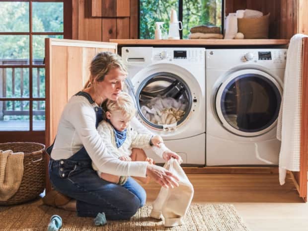 Adult and young child working together to clean blankets