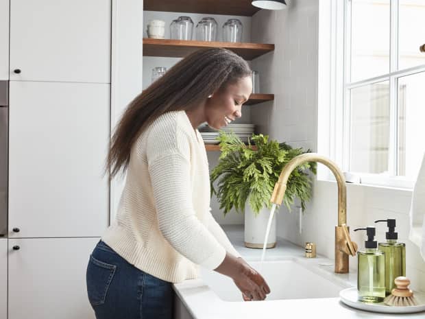 Woman washing hands at sink